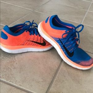 Blue and orange Nike Free 4.0 Flyknit sneakers.